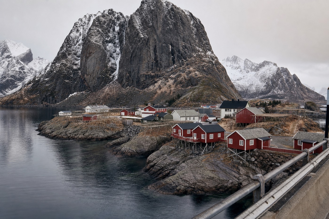 Hamnøy's red rorbu cabins beneath Festhaeltinden