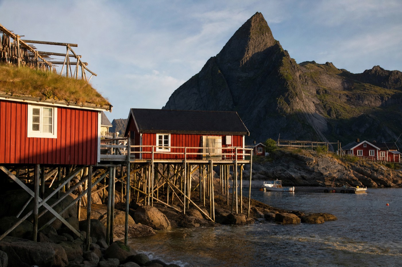 Hamnøy's red rorbu cabins beneath Festhaeltinden