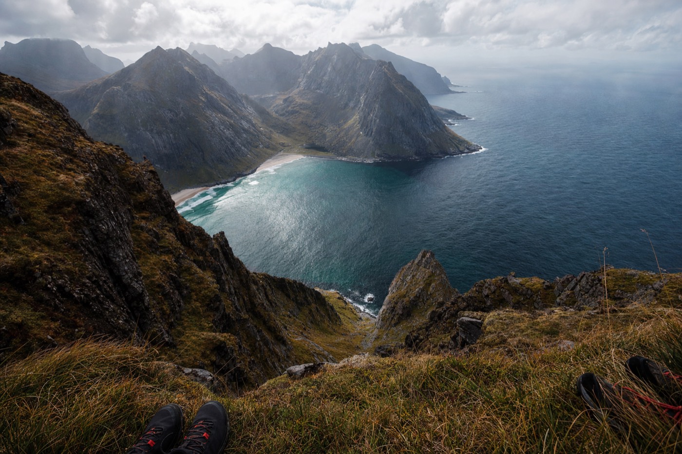 A panoramic view from the Ryten summit down over remote Kvalvika beach in Lofoten